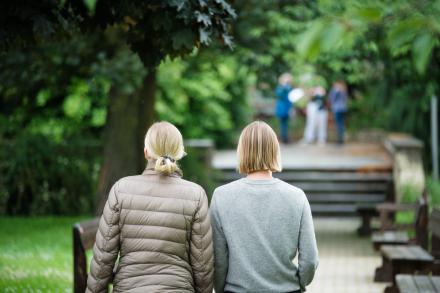 Two people walking side by side