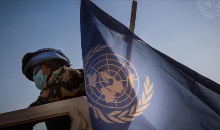 UN peacekeeper with UN flag