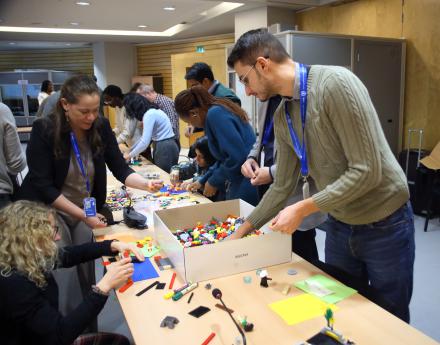 Participants using Legos engaging in an activity using Legos
