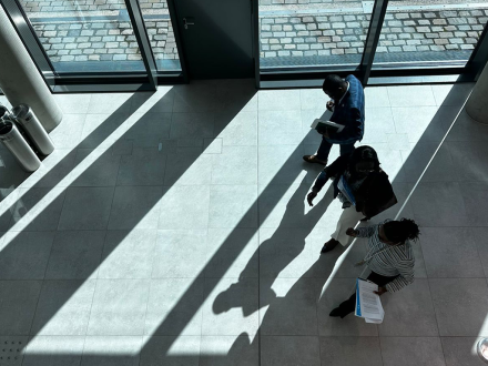 bird-view of three people walking in a corridor