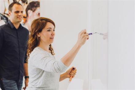 Woman writing on a whiteboard 