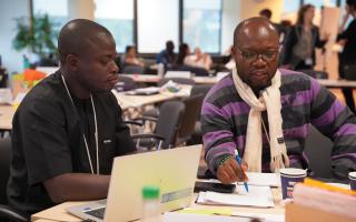 Two colleagues exchanging ideas during a UNSSC workshop