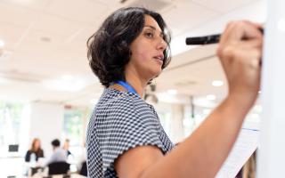 Person writing on a whiteboard
