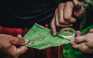 Two people who a map and a compass
