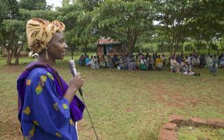 Woman addressing a crowd outside