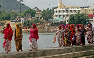 Women walking across a bridge