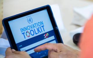 A tablet with the Innovation Toolkit logo on the screen 