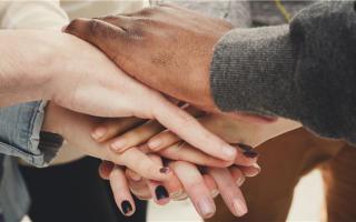 Hands stacked on top of each other