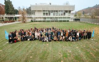 Group picture of 2026 JPO Orientation Programme participants at UNSSC, seen standing in a grass field from above