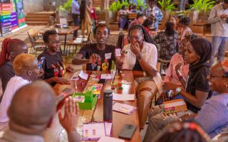 Young people playing the Ballot Battle card game