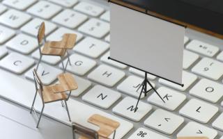 miniature chairs and whiteboard on a keyboard