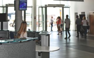 Entrance of a big building with people entering and exiting